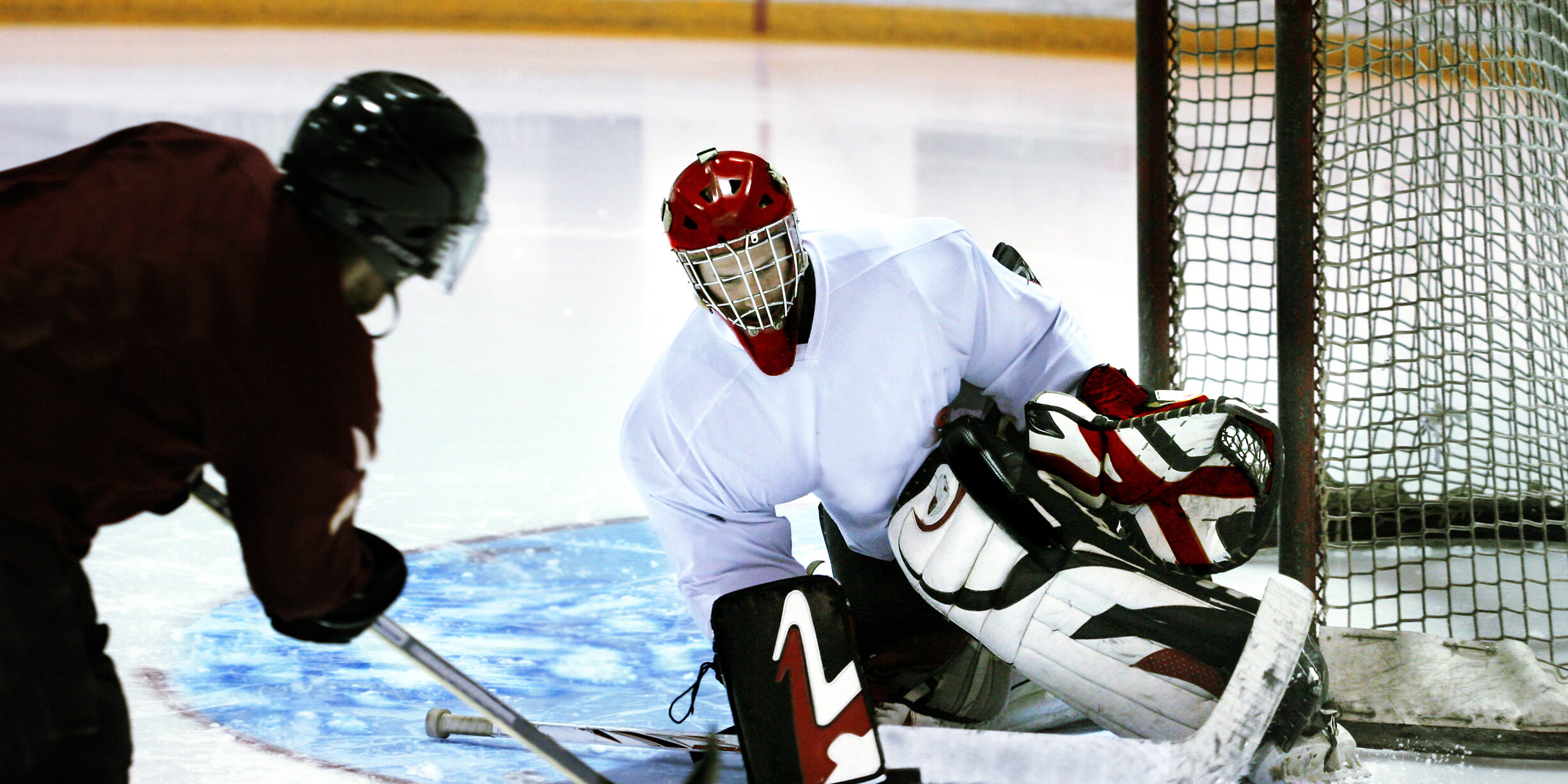 ice hockey goalie stopping shot